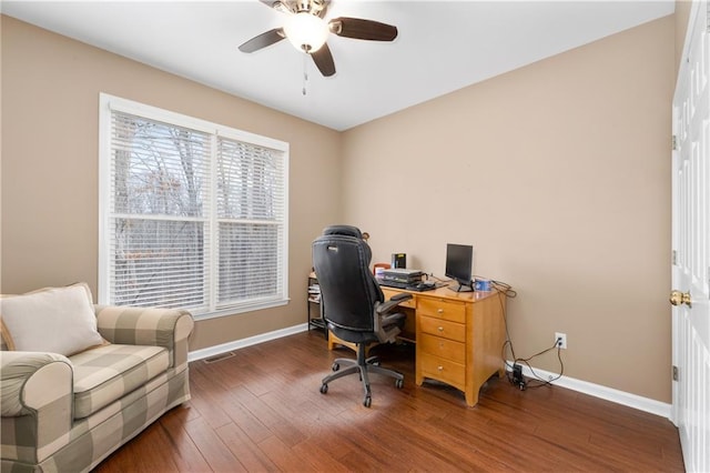 office with dark wood-type flooring and ceiling fan