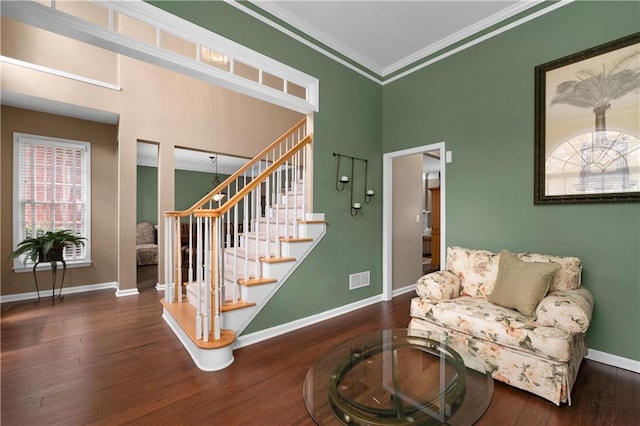 living area with crown molding and dark hardwood / wood-style flooring