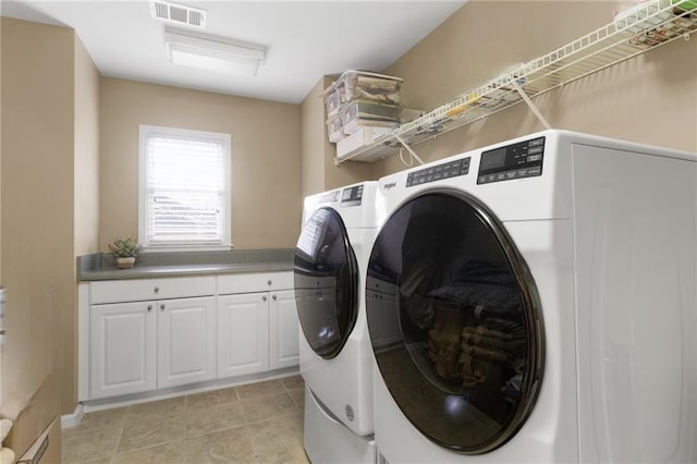 washroom with separate washer and dryer and light tile patterned floors