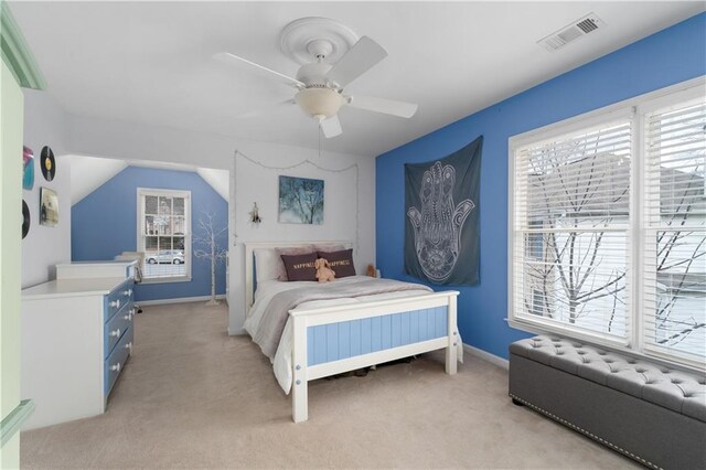 bedroom with vaulted ceiling and light colored carpet