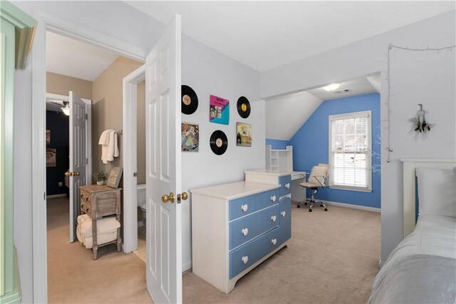 office area featuring vaulted ceiling and light carpet