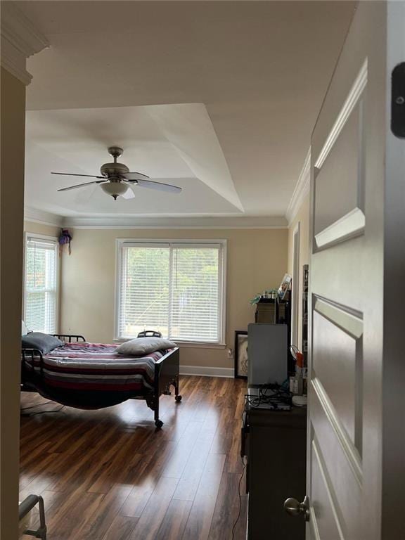 bedroom with ceiling fan, crown molding, and dark hardwood / wood-style floors