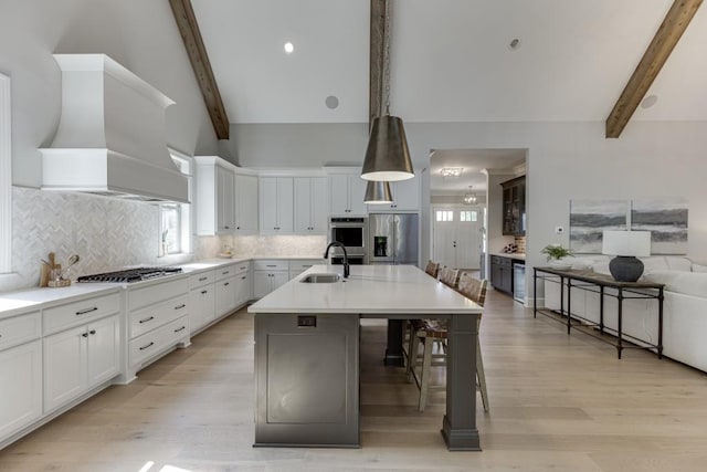 4781 Falling Brook Dr, Flowery Branch, GA 30542 - kitchen with stainless steel appliances, premium range hood, a sink, and healthy amount of natural light