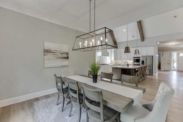 4781 Falling Brook Dr, Flowery Branch, GA 30542 - dining area with baseboards, light wood finished floors, and a chandelier