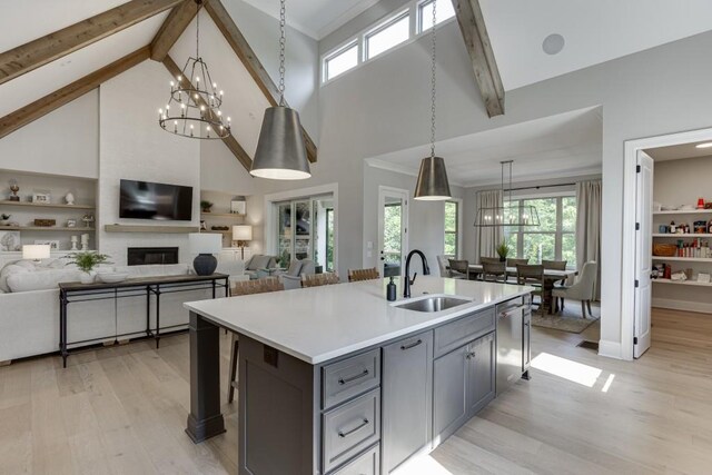 4781 Falling Brook Dr, Flowery Branch, GA 30542 - kitchen with a sink, gray cabinets, a chandelier, light countertops, and high vaulted ceiling