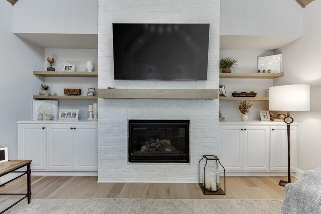 4781 Falling Brook Dr, Flowery Branch, GA 30542 - living area featuring light wood finished floors and a brick fireplace