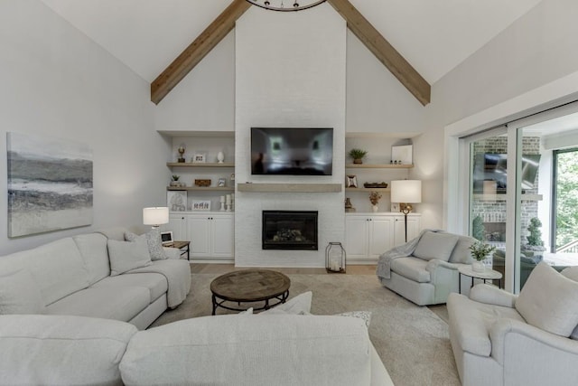 4781 Falling Brook Dr, Flowery Branch, GA 30542 - living room featuring light wood-style flooring, high vaulted ceiling, beamed ceiling, a large fireplace, and built in features
