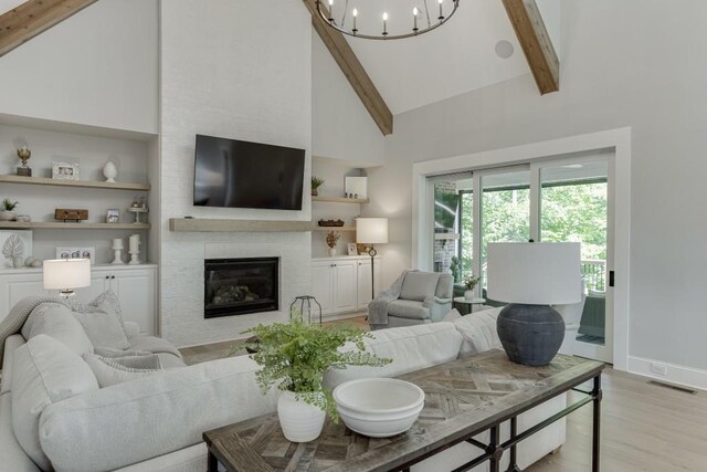4781 Falling Brook Dr, Flowery Branch, GA 30542 - living room with high vaulted ceiling, beamed ceiling, light wood finished floors, a fireplace, and baseboards
