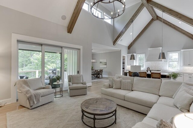 4781 Falling Brook Dr, Flowery Branch, GA 30542 - living area featuring high vaulted ceiling, beamed ceiling, light wood-type flooring, a chandelier, and baseboards