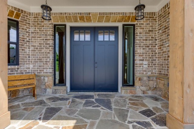 4781 Falling Brook Dr, Flowery Branch, GA 30542 - doorway to property with a porch, brick siding, and stone siding