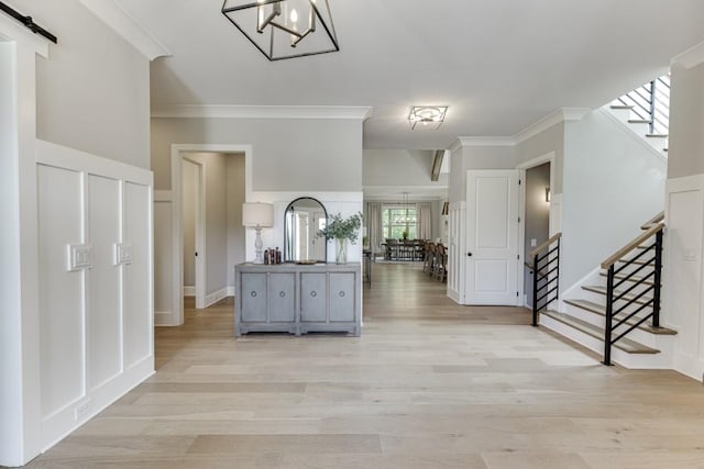 4781 Falling Brook Dr, Flowery Branch, GA 30542 - foyer featuring stairway, crown molding, light wood-type flooring, a chandelier, and a barn door