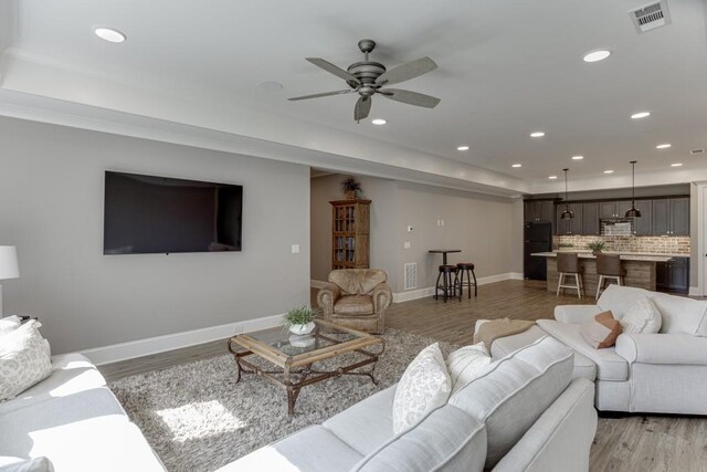 4781 Falling Brook Dr, Flowery Branch, GA 30542 - living room with recessed lighting, a ceiling fan, light wood finished floors, baseboards, and a tray ceiling