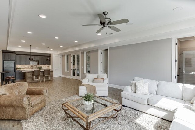 4781 Falling Brook Dr, Flowery Branch, GA 30542 - living area featuring light wood-style flooring, a ceiling fan, recessed lighting, and baseboards