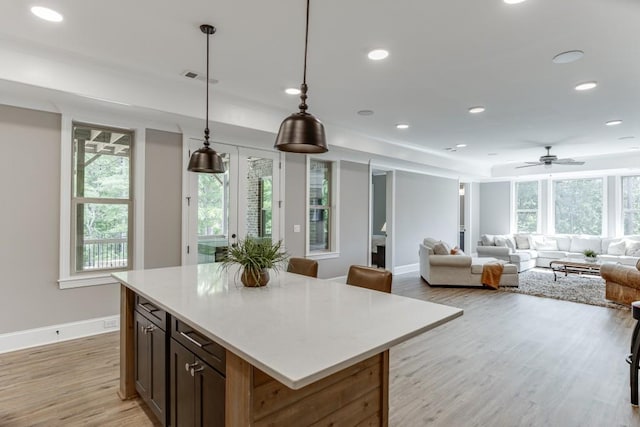 4781 Falling Brook Dr, Flowery Branch, GA 30542 - kitchen featuring healthy amount of natural light, light wood-type flooring, baseboards, recessed lighting, and light countertops