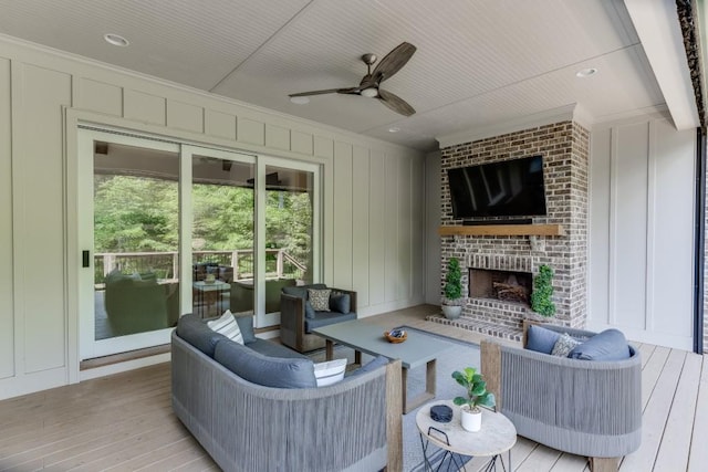 4781 Falling Brook Dr, Flowery Branch, GA 30542 - living area featuring a decorative wall, ceiling fan, hardwood / wood-style floors, crown molding, and a brick fireplace