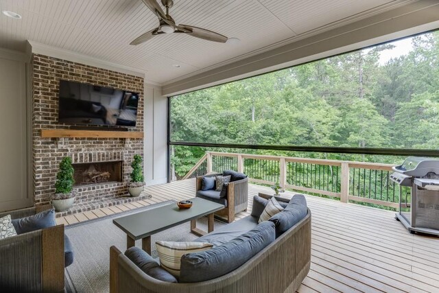 4781 Falling Brook Dr, Flowery Branch, GA 30542 - deck with an outdoor living space with a fireplace, area for grilling, ceiling fan, and a view of trees