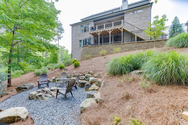 4781 Falling Brook Dr, Flowery Branch, GA 30542 - back of house featuring an outdoor fire pit, stairs, and stone siding