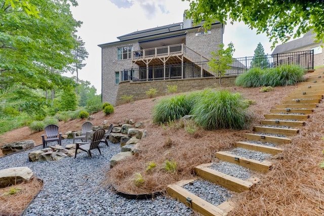 4781 Falling Brook Dr, Flowery Branch, GA 30542 - rear view of house with stairway and an outdoor fire pit