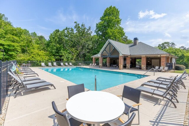 4781 Falling Brook Dr, Flowery Branch, GA 30542 - community pool with a patio and view of scattered trees