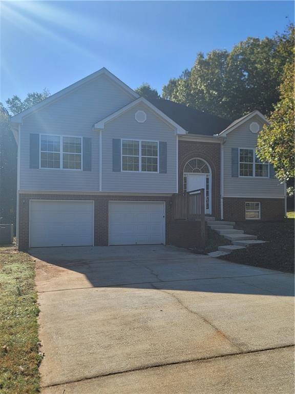 split foyer home featuring cooling unit and a garage