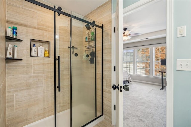 bathroom featuring ceiling fan and an enclosed shower