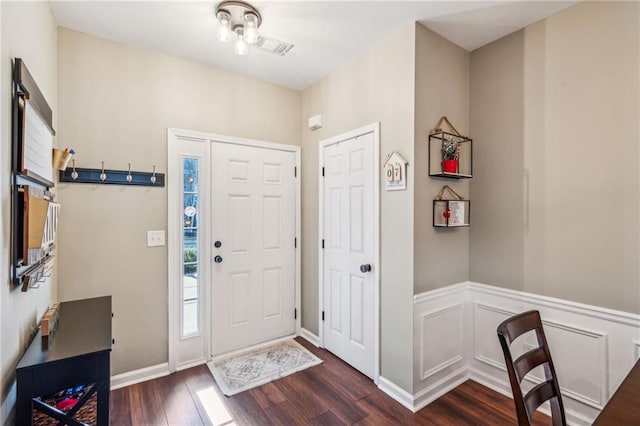 entryway with dark hardwood / wood-style flooring