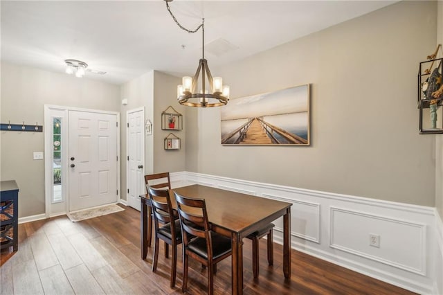 dining room featuring dark wood-type flooring and a notable chandelier