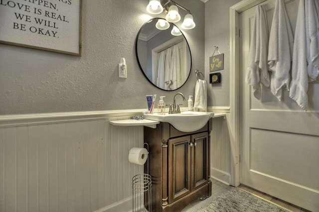 bathroom featuring wooden walls and vanity