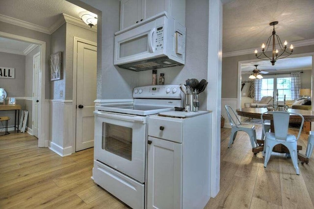 kitchen featuring ornamental molding, light hardwood / wood-style floors, white appliances, and white cabinetry