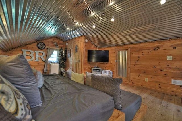 living room featuring vaulted ceiling, wood walls, wooden ceiling, and hardwood / wood-style floors