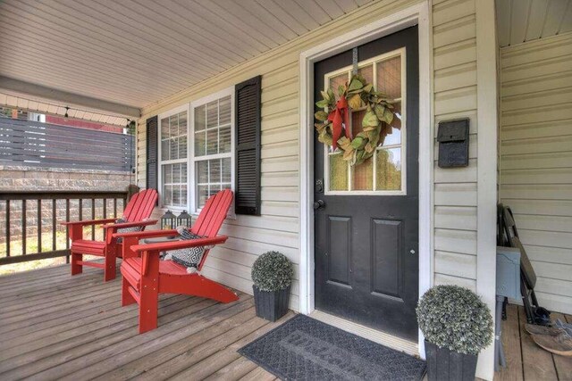 doorway to property featuring covered porch