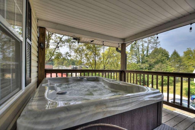 wooden deck featuring a hot tub