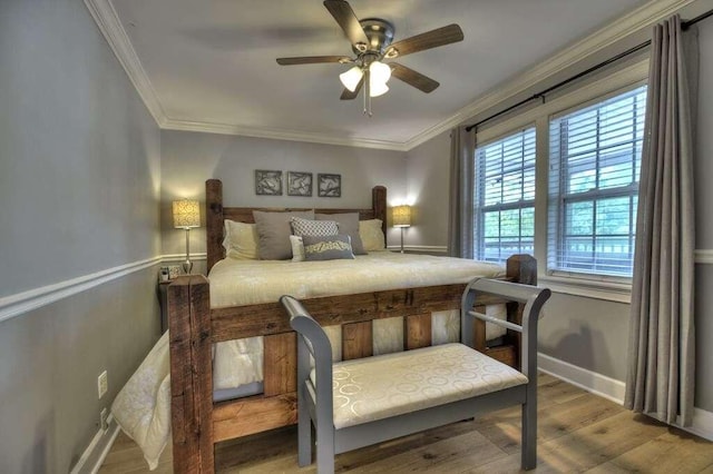 bedroom with crown molding, ceiling fan, and hardwood / wood-style flooring