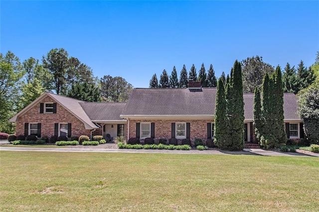 1935 Northbrooke Ln, Dunwoody, GA 30338 - view of front facade featuring a front yard, brick siding, and a chimney