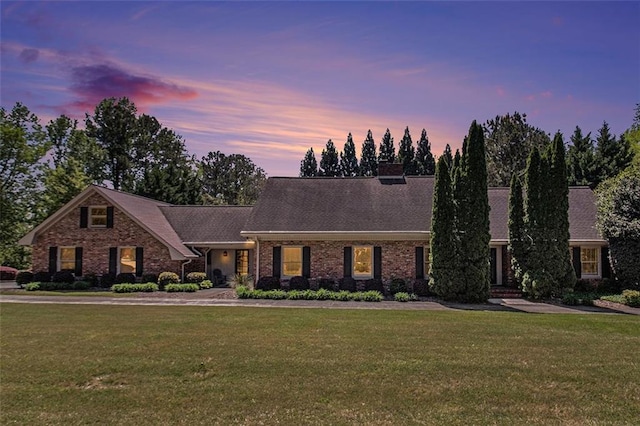 1935 Northbrooke Ln, Dunwoody, GA 30338 - view of front of property featuring a lawn, brick siding, and a chimney