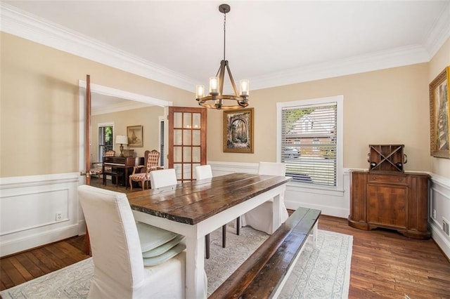 1935 Northbrooke Ln, Dunwoody, GA 30338 - dining room with a chandelier, dark wood-style flooring, crown molding, wainscoting, and a decorative wall