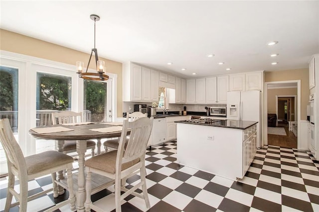 1935 Northbrooke Ln, Dunwoody, GA 30338 - kitchen with light floors, appliances with stainless steel finishes, dark countertops, white cabinetry, and recessed lighting