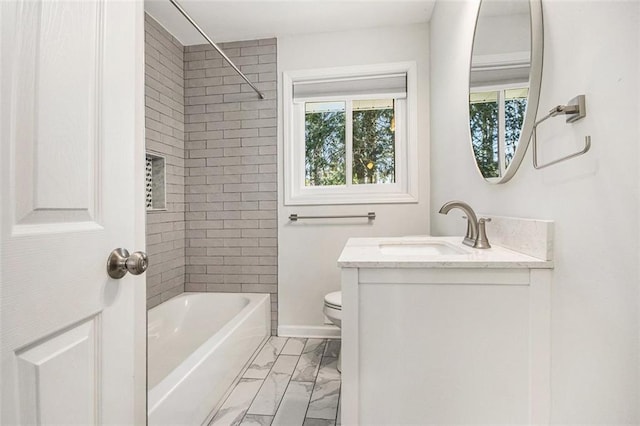 full bathroom featuring toilet, marble finish floor, washtub / shower combination, baseboards, and vanity