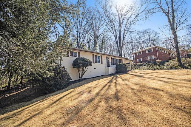 view of front of home with stucco siding and a front lawn