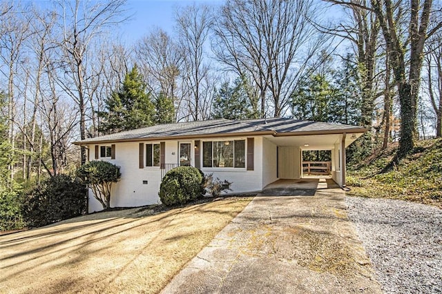 single story home with an attached carport, concrete driveway, and brick siding