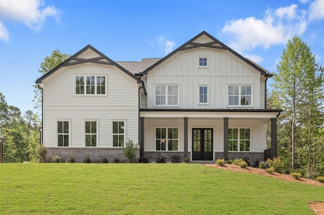 4525 Aiden Way, Cumming, GA 30041 - view of front of home featuring french doors, brick siding, a front yard, and board and batten siding