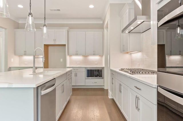 4525 Aiden Way, Cumming, GA 30041 - kitchen featuring appliances with stainless steel finishes, wall chimney range hood, recessed lighting, decorative backsplash, and hanging light fixtures