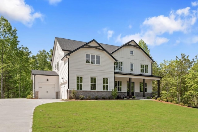 4525 Aiden Way, Cumming, GA 30041 - view of front of home with driveway, a front lawn, board and batten siding, an attached garage, and brick siding