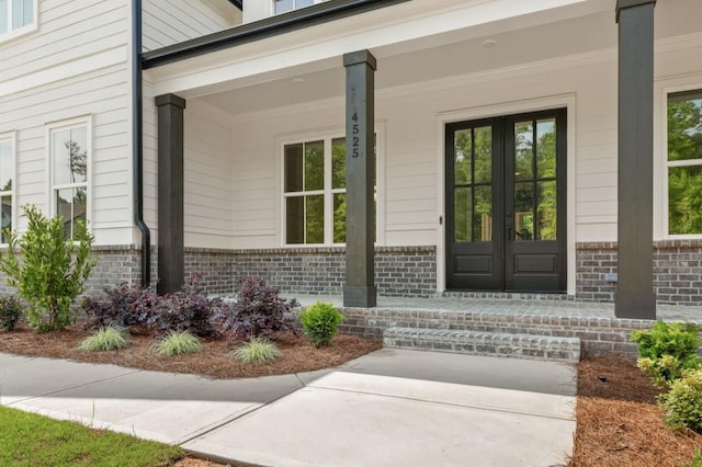 4525 Aiden Way, Cumming, GA 30041 - view of exterior entry with brick siding, french doors, and covered porch