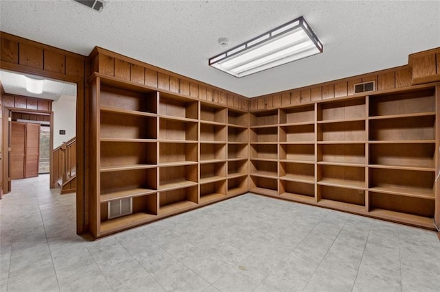 4116 River Cliff Chase SE, Marietta, GA 30067 - unfurnished room featuring a textured ceiling, wood walls, and light tile patterned floors