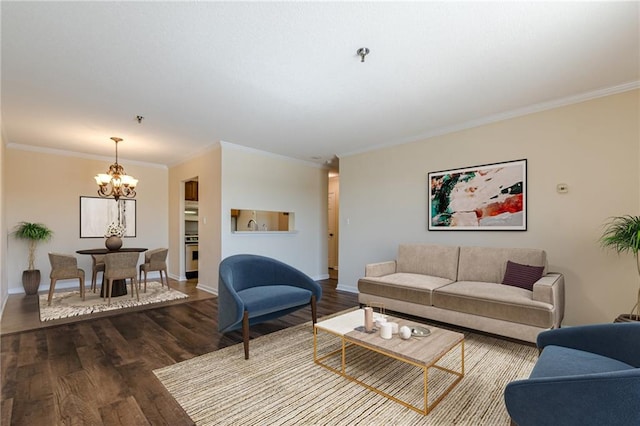 living room with ornamental molding, a chandelier, and wood-type flooring