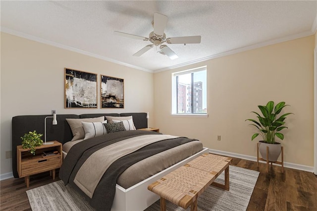 bedroom featuring dark hardwood / wood-style flooring, ornamental molding, a textured ceiling, and ceiling fan