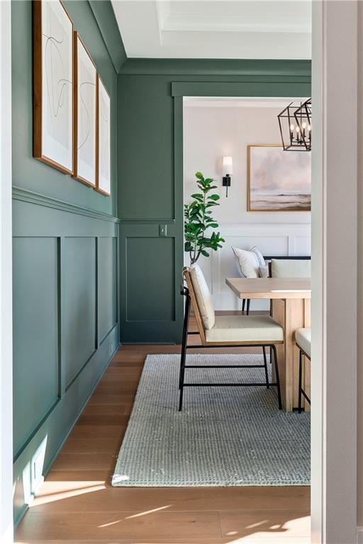 doorway with hardwood / wood-style floors and a chandelier