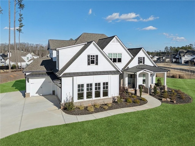 view of front of house with a front yard and a garage