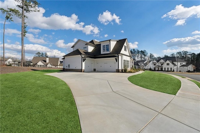 view of front of property featuring a garage and a front lawn